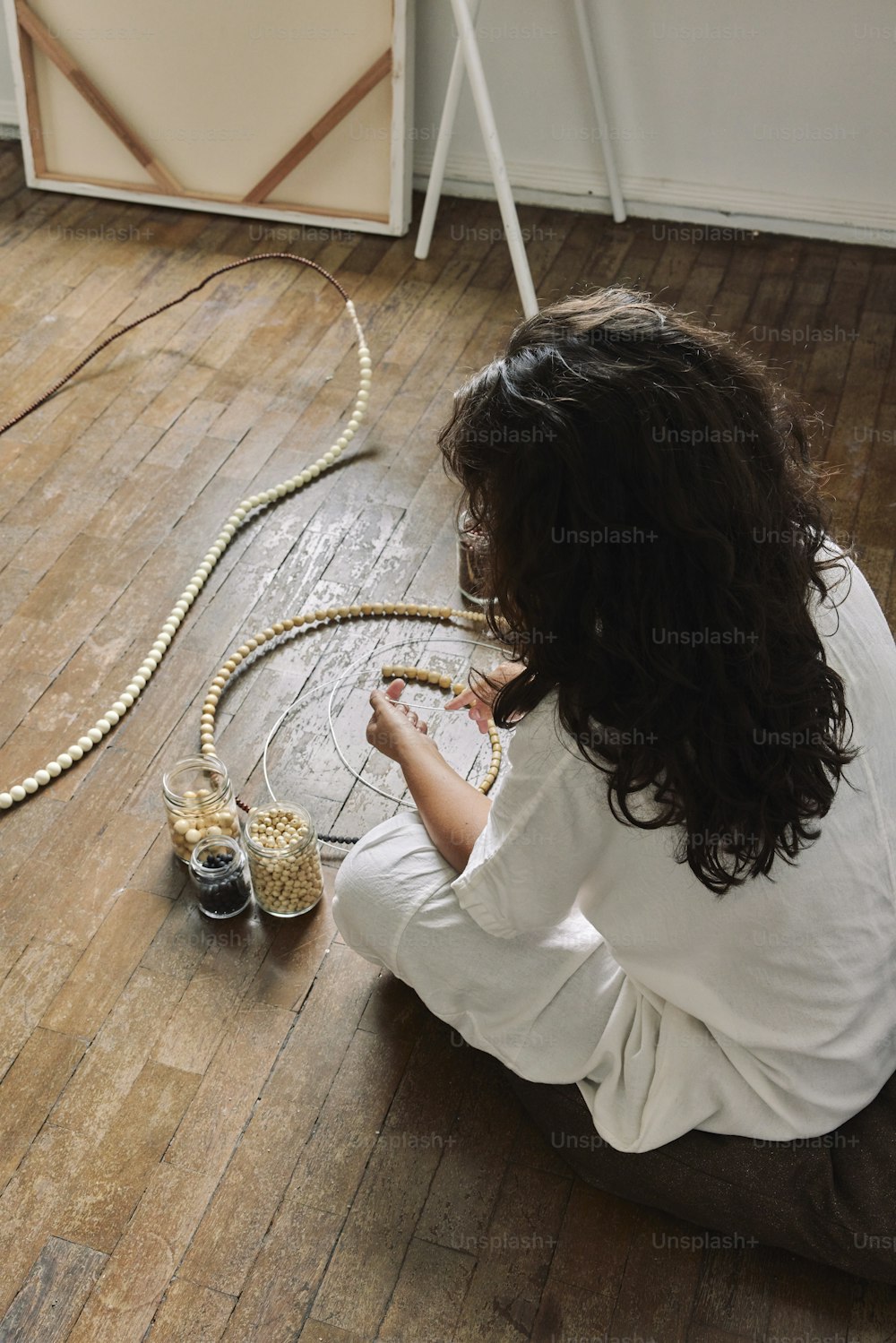 a woman sitting on the floor next to a snake