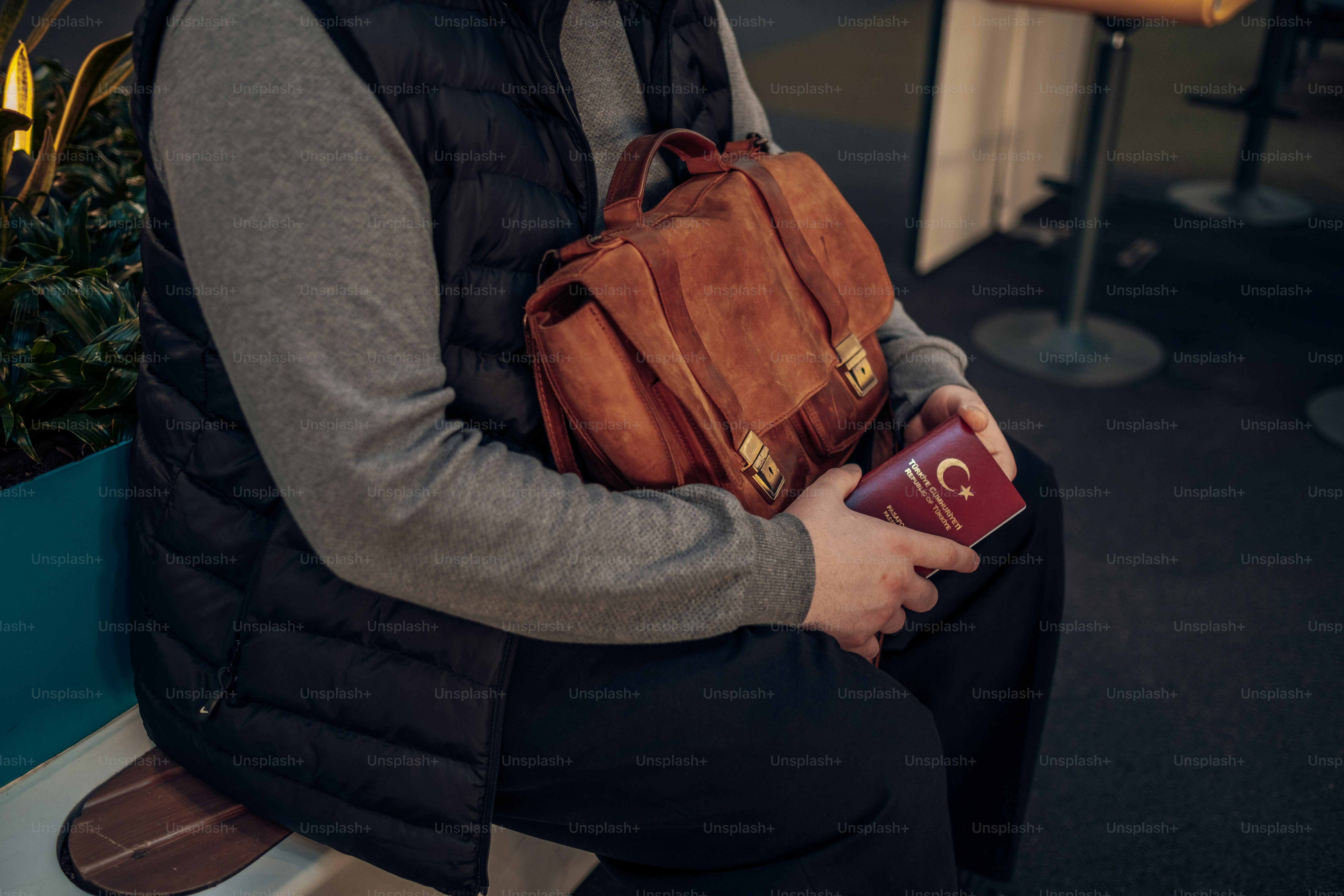 a man sitting on a bench holding a book
