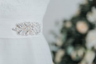 a close up of a dress with a flower on it