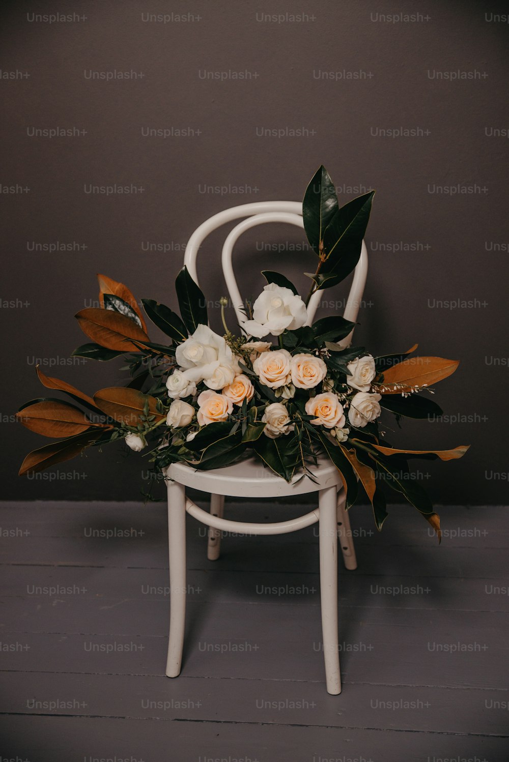 a white chair with a bunch of flowers on it