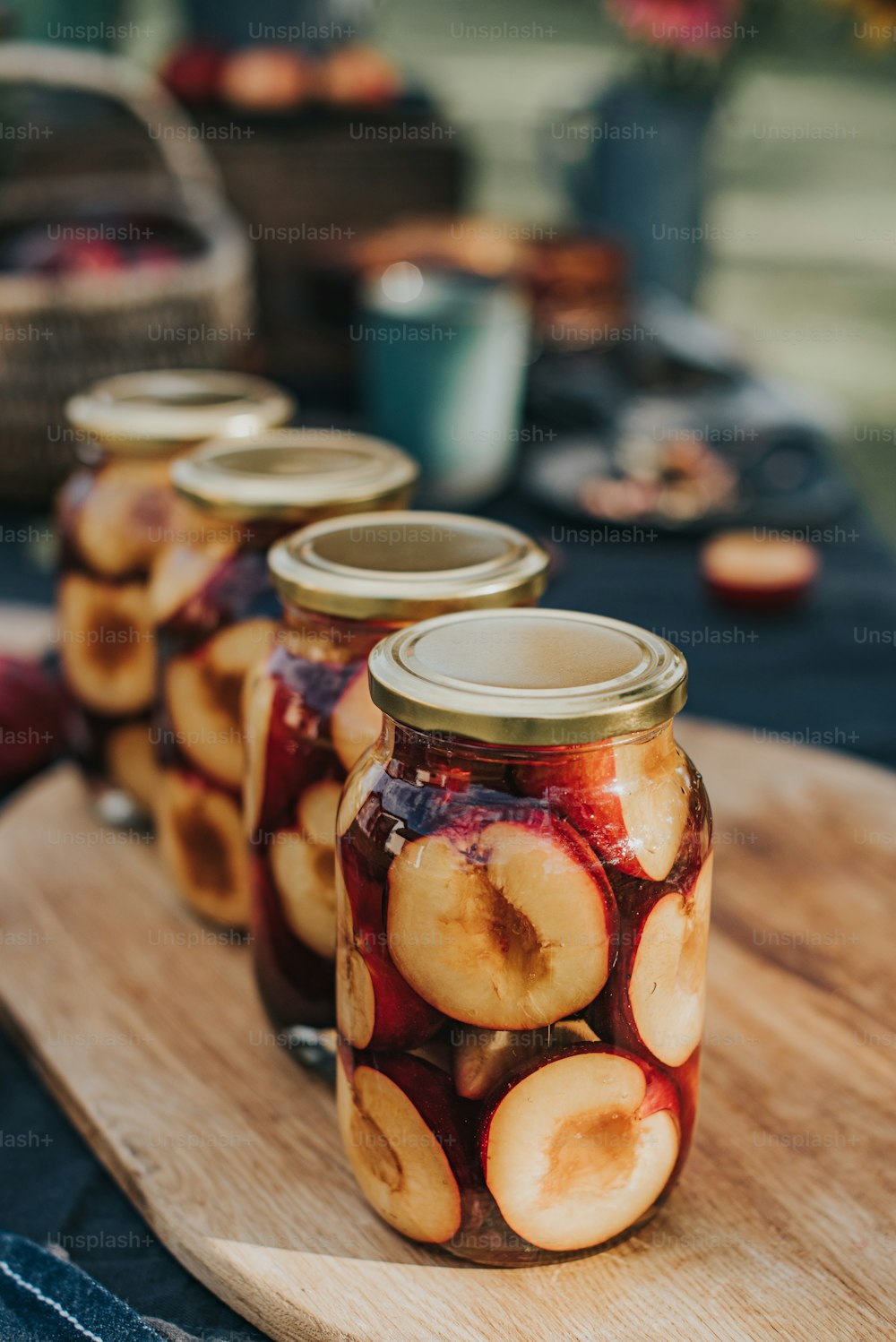 a wooden tray topped with jars filled with fruit