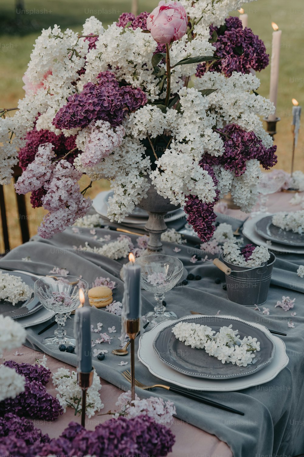 a table set with plates and flowers on it