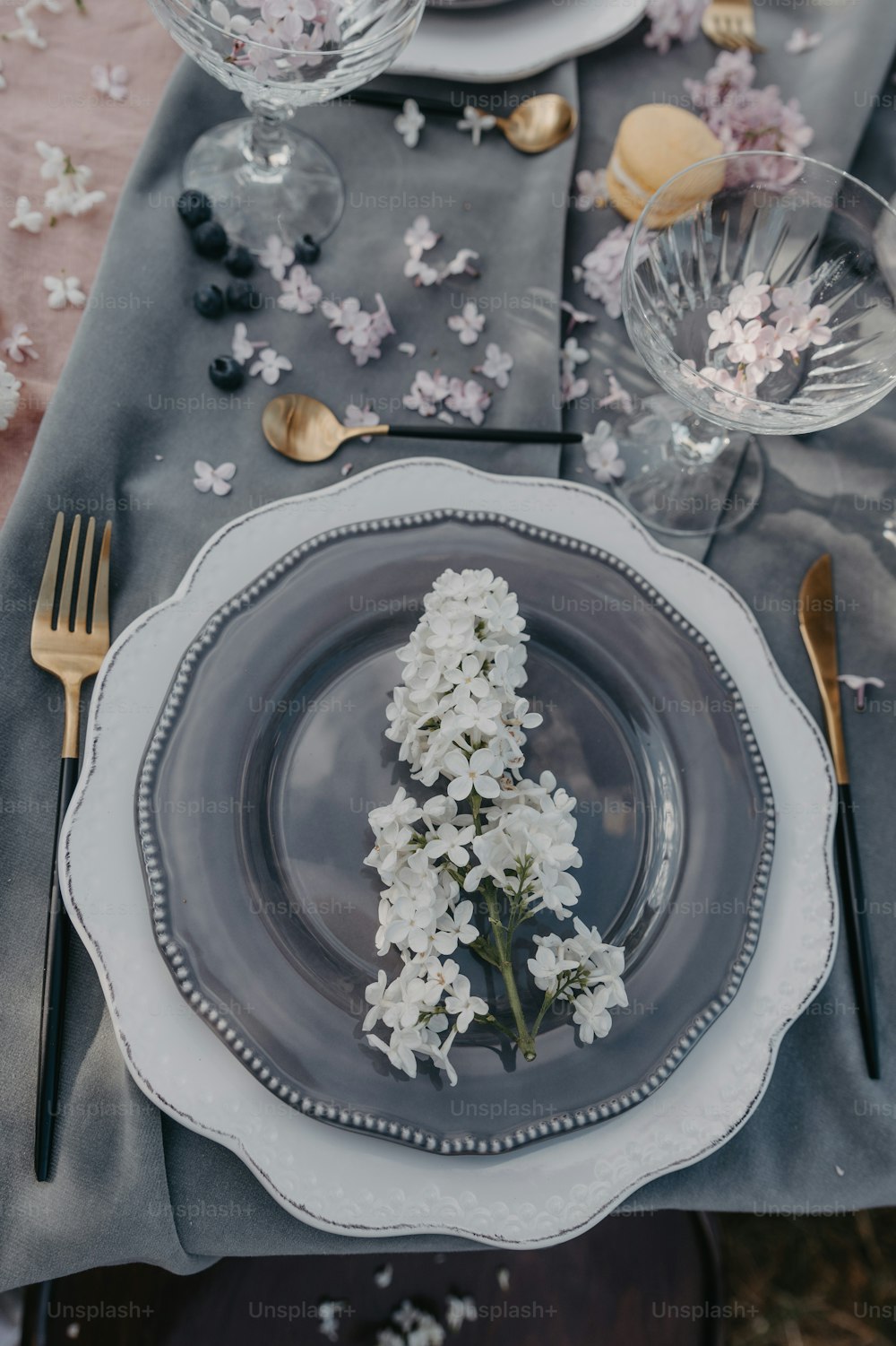 a place setting with flowers on a table