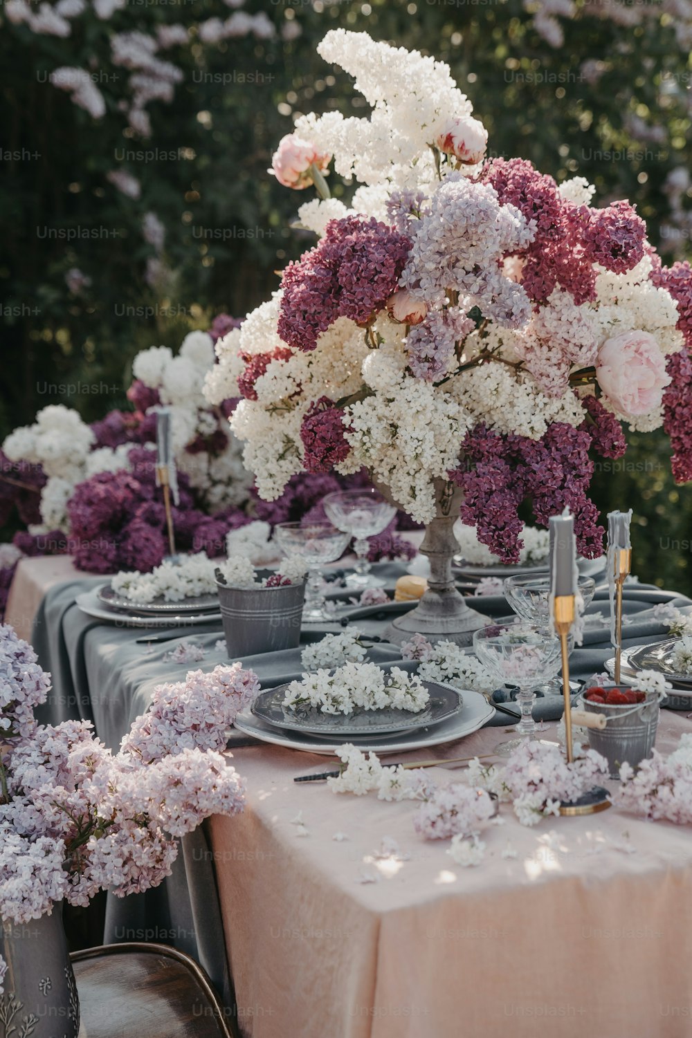 a table is set with plates and flowers