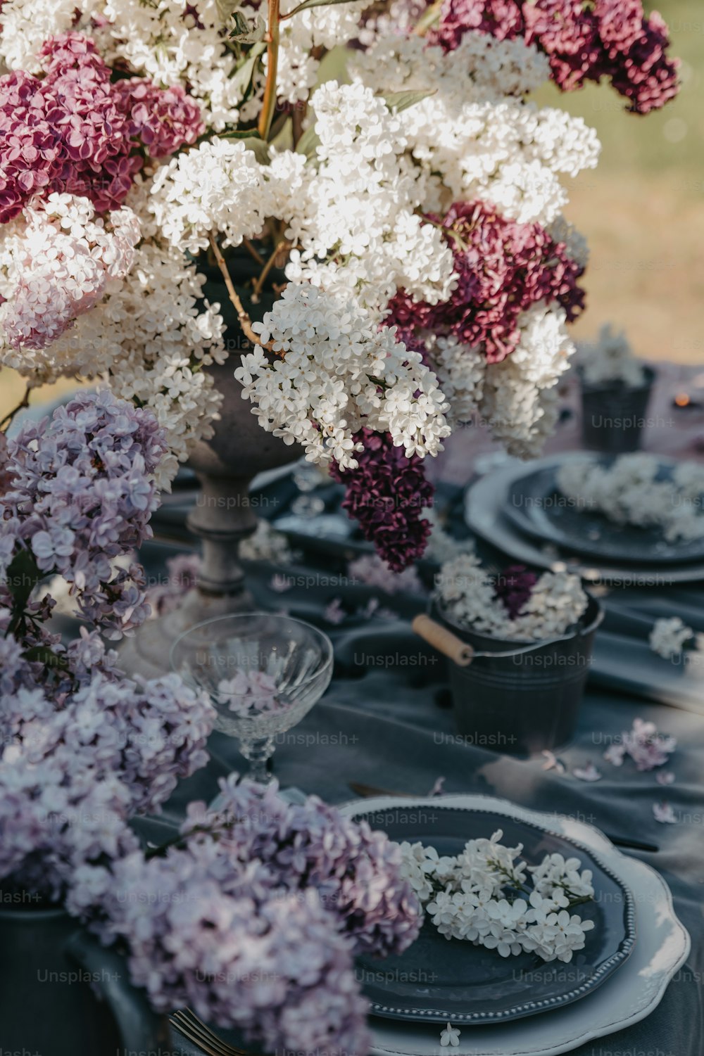 a table topped with purple and white flowers