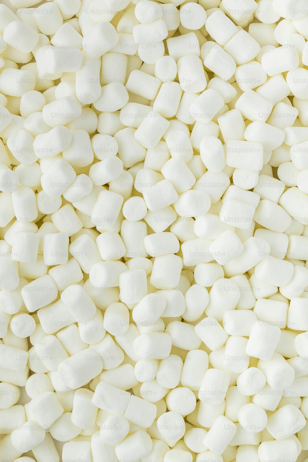 a pile of white marshmallows sitting on top of each other