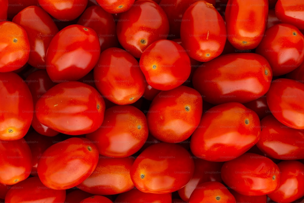 a close up of a bunch of red tomatoes