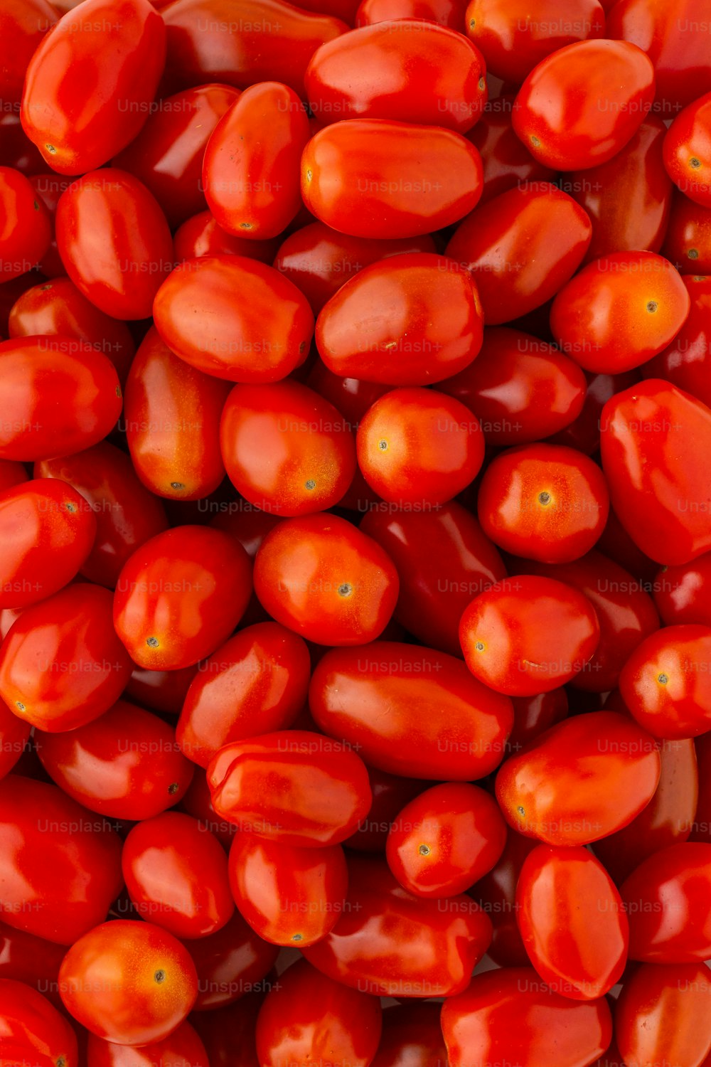 a pile of red tomatoes sitting on top of each other