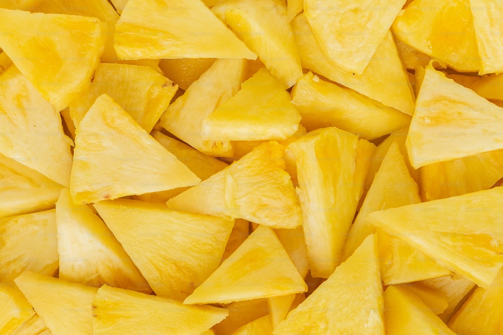 a pile of cut up pineapples sitting next to each other