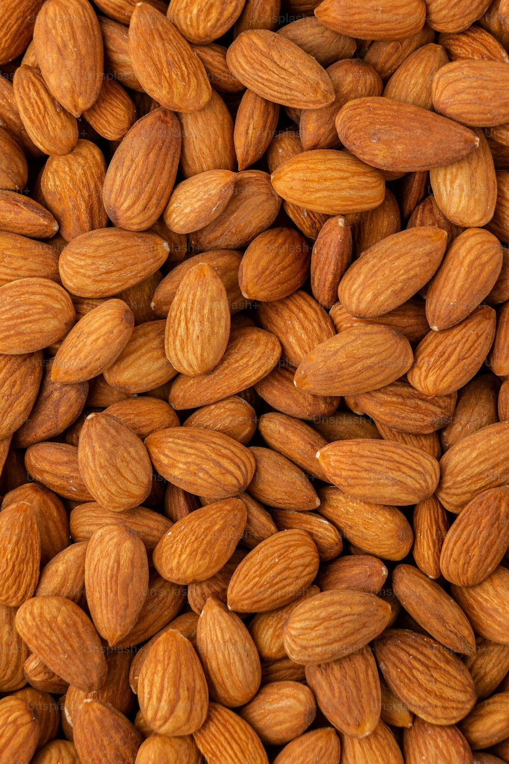 a pile of almonds is shown close up