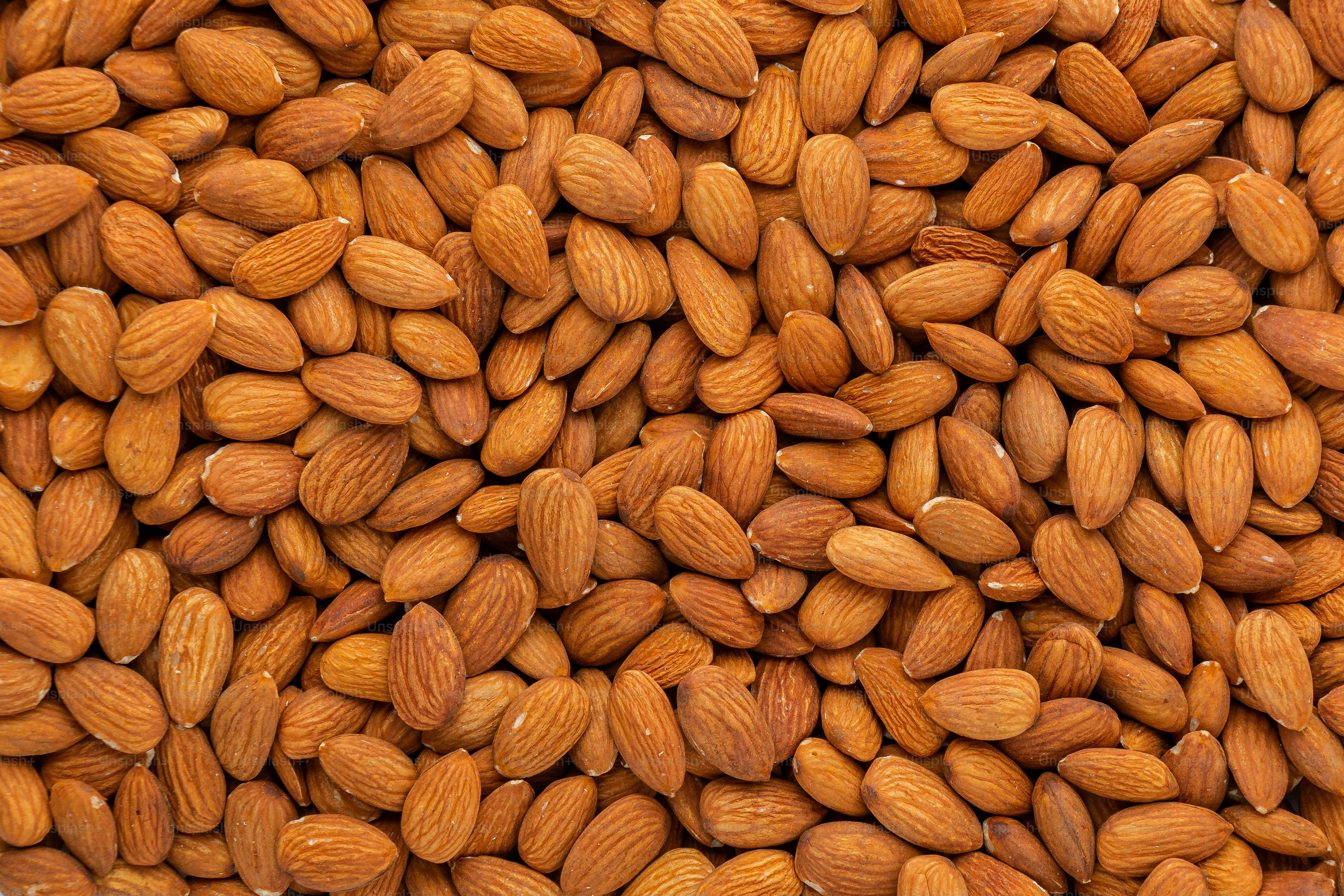 a pile of almonds sitting next to each other