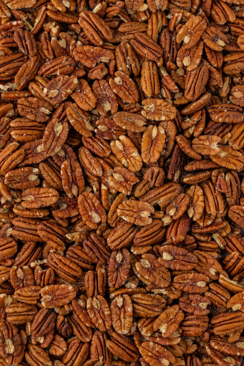 a pile of pecans is shown close up