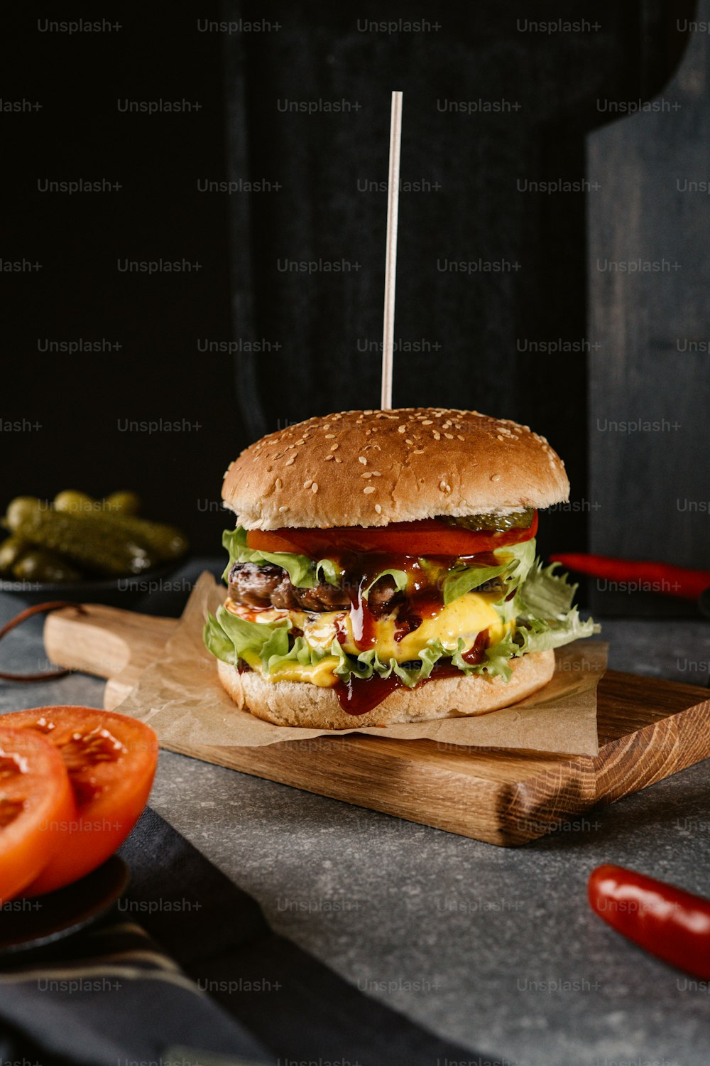 a hamburger sitting on top of a wooden cutting board