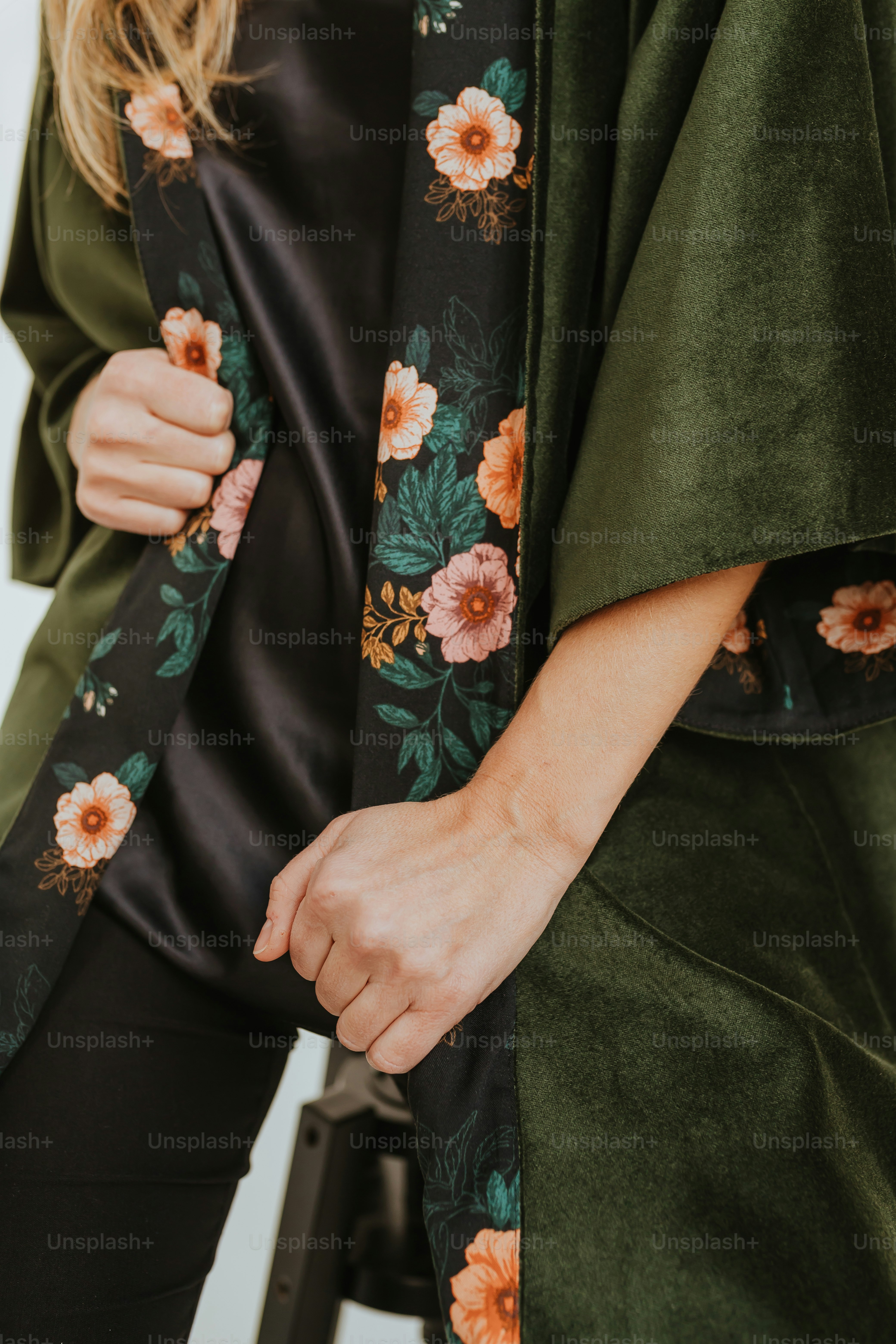 a woman wearing a green floral kimono
