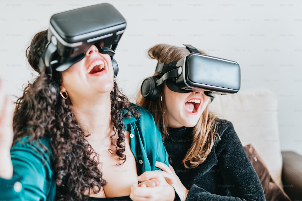 a couple of women wearing virtual glasses on top of a couch