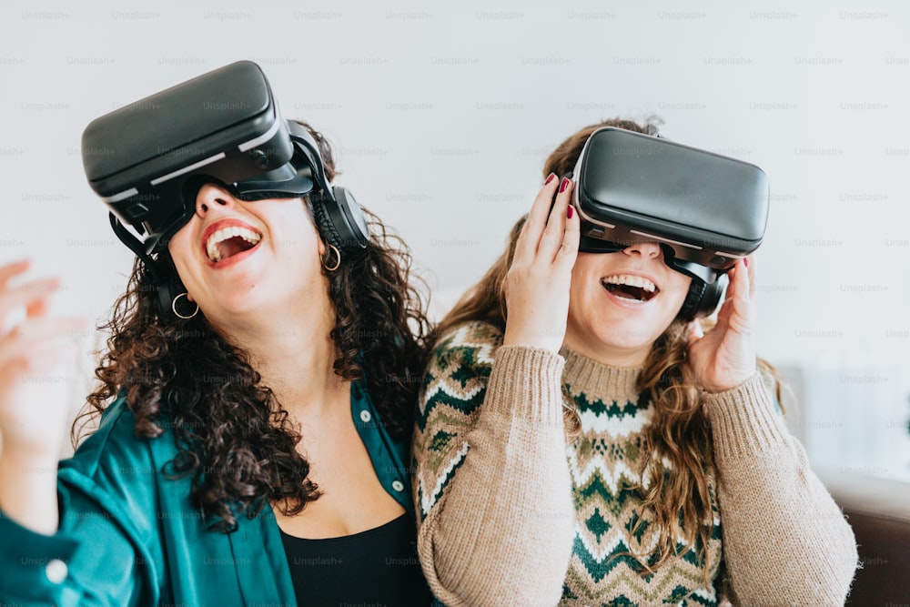 two women wearing virtual headsets and laughing