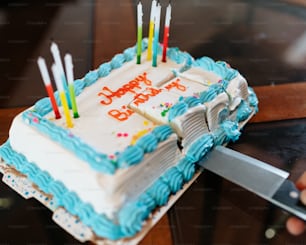 a birthday cake with lit candles on a table