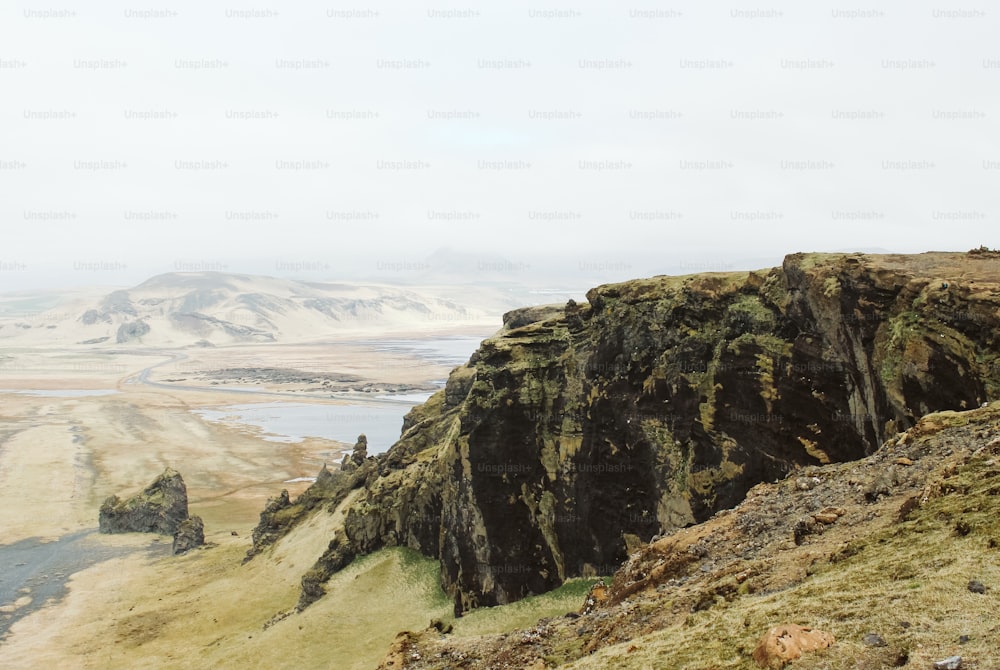 a view of a mountain with a body of water in the distance