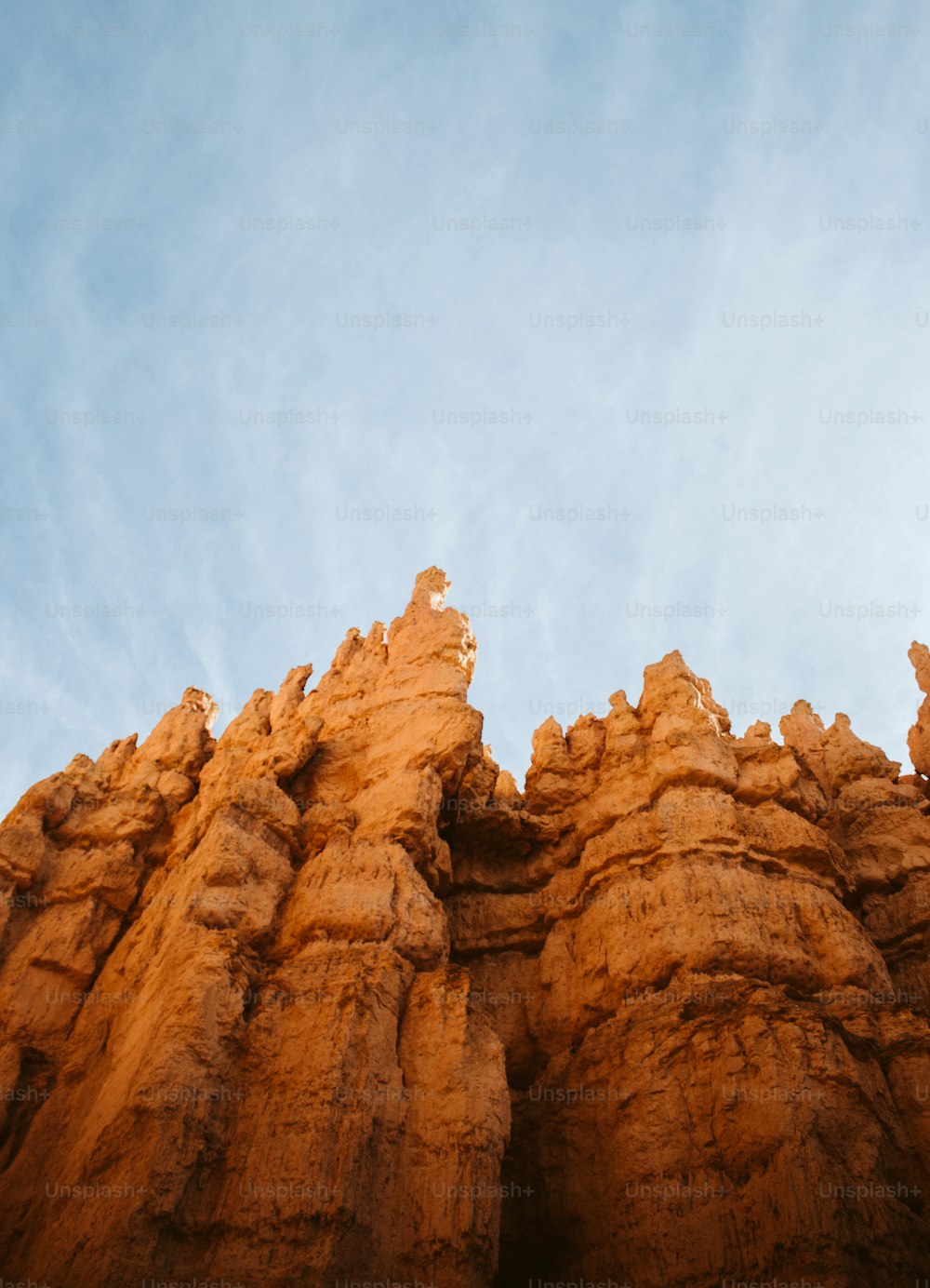 a very tall rock formation under a blue sky