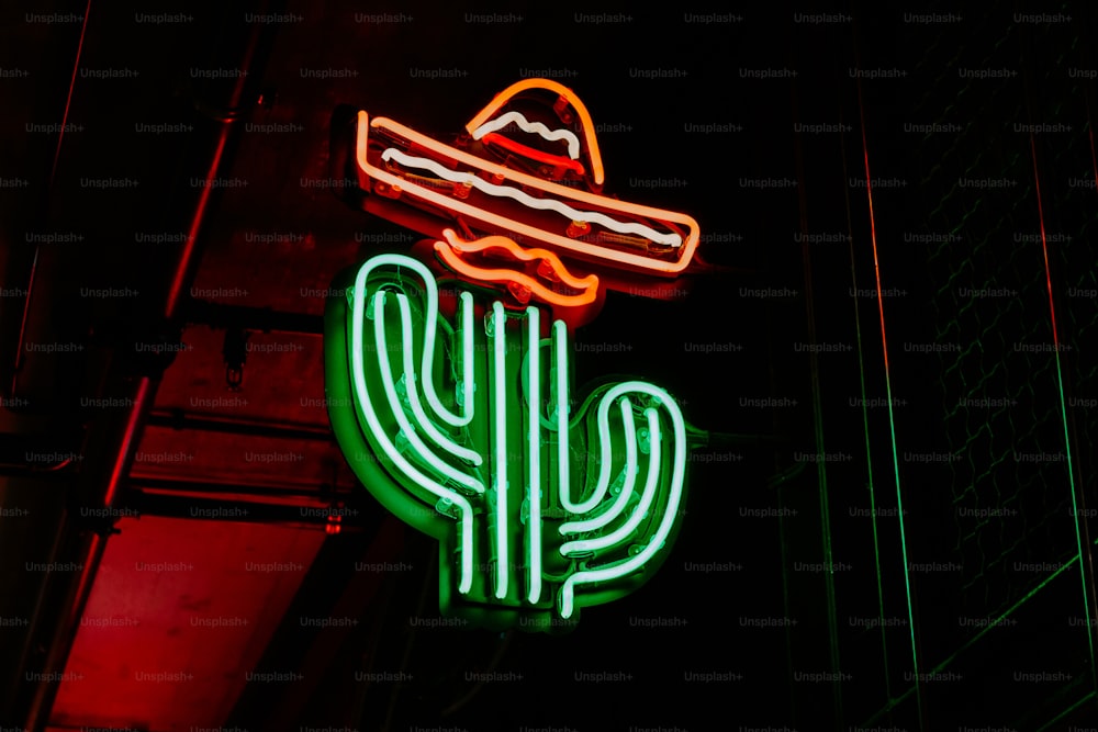 a neon sign with a taco and a hat on top of it