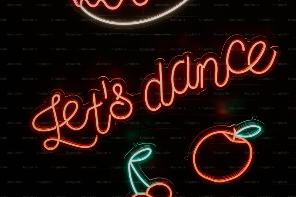 a neon sign that says let's dance