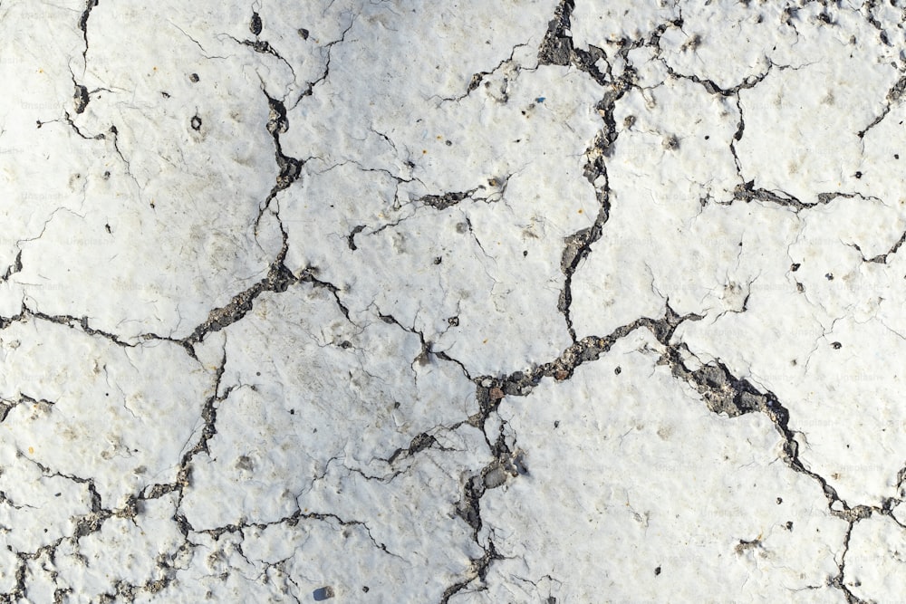 a close up of a cracked concrete surface