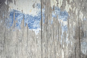 a wooden wall with peeling paint on it