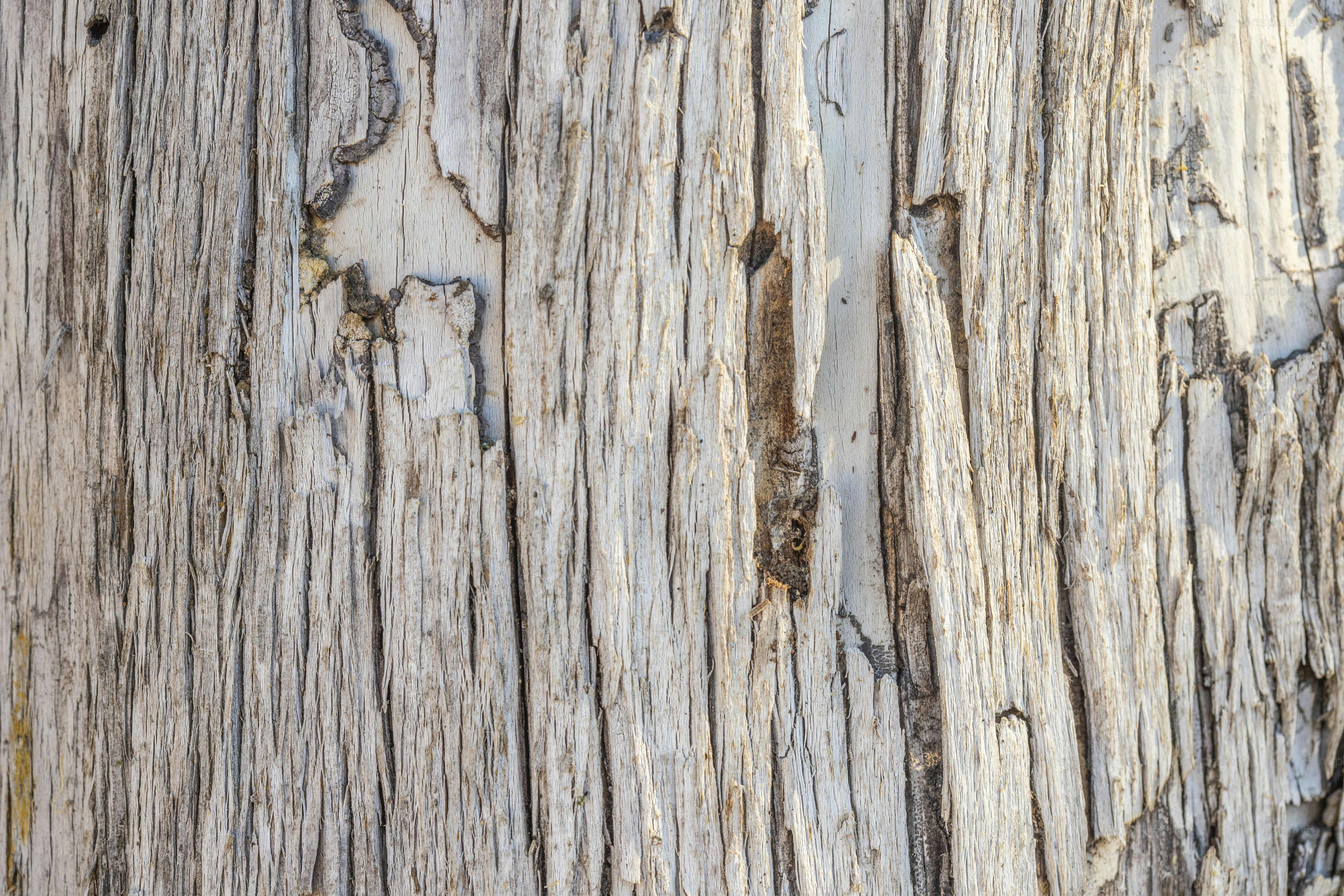 a close up of a wooden surface with peeling paint