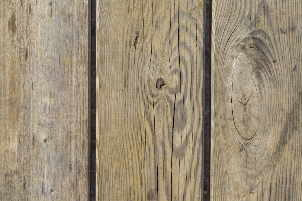 a close up of a wooden fence with knots