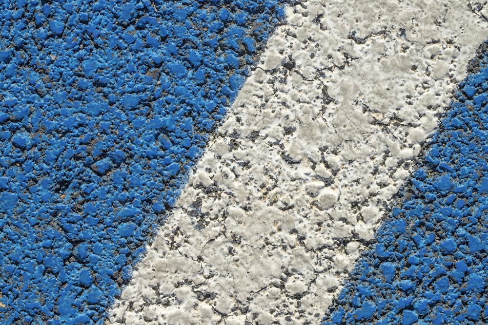 a close up of a blue and white street sign