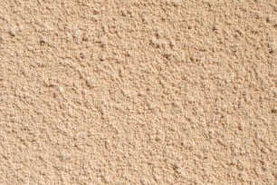 a close up view of a tan colored wall