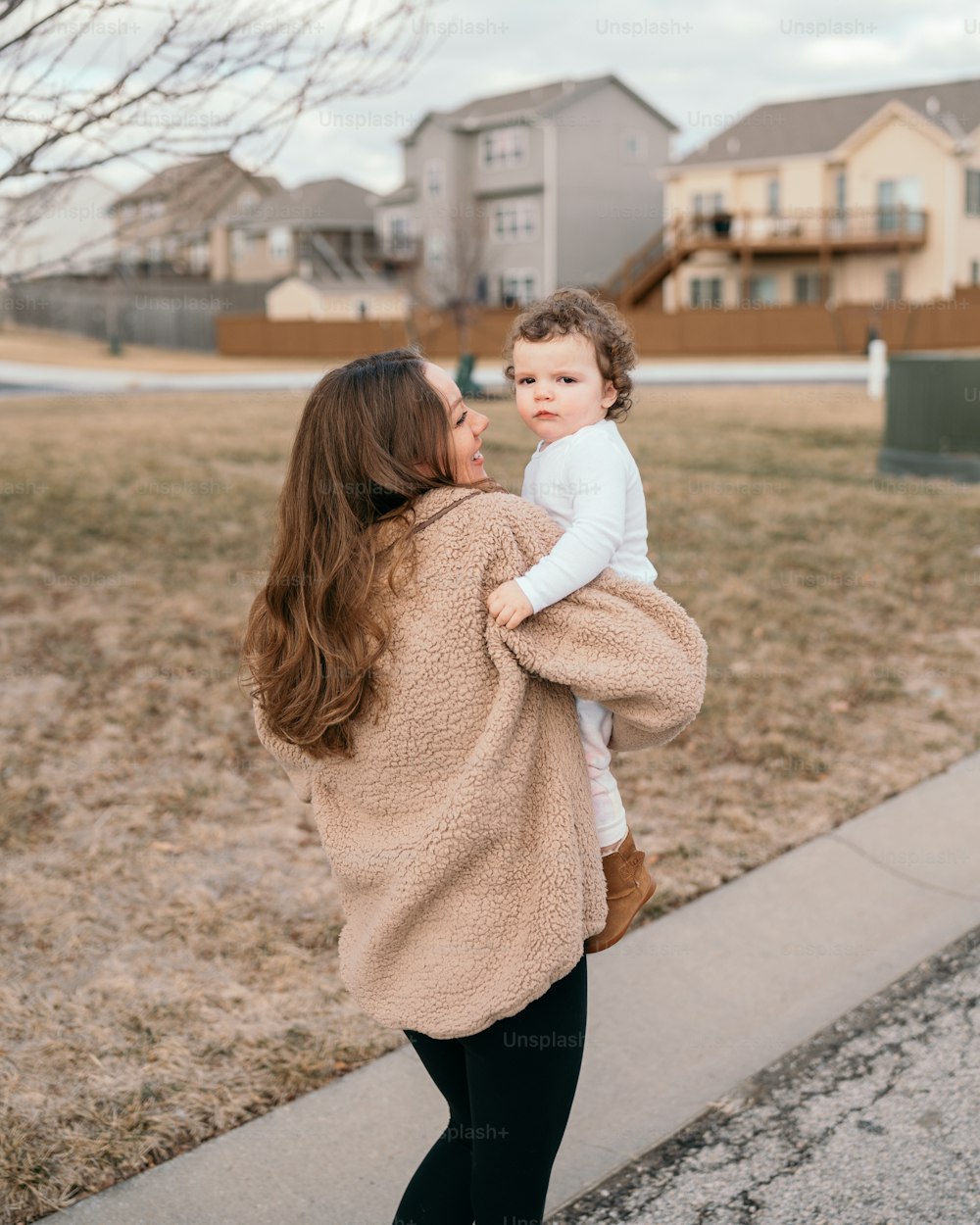 a woman holding a small child in her arms