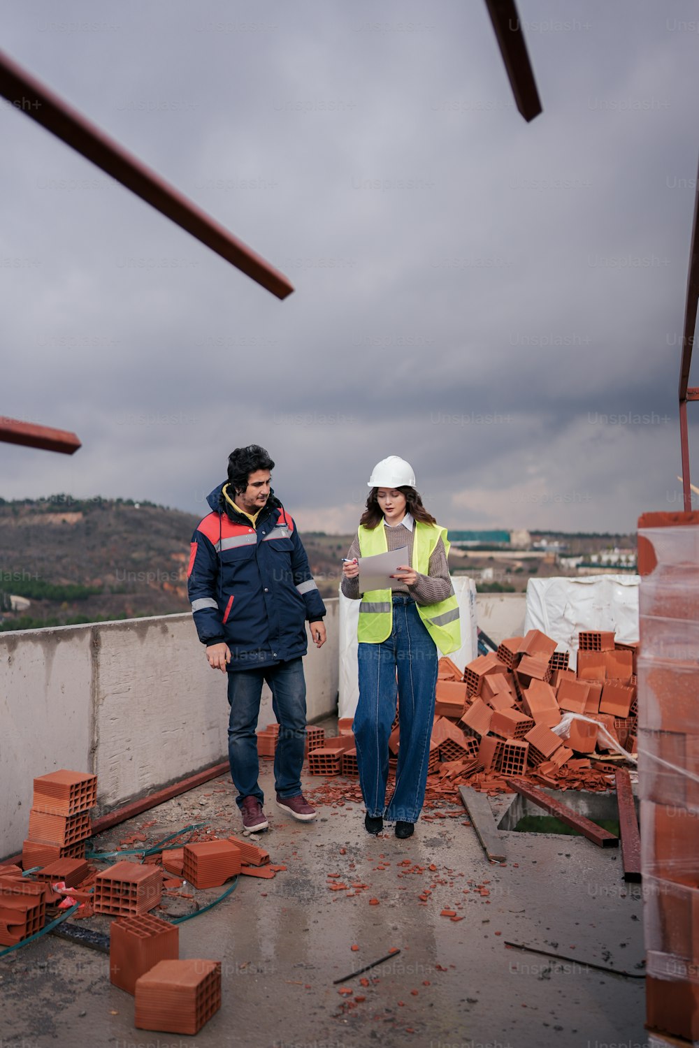 a man and a woman standing on a roof