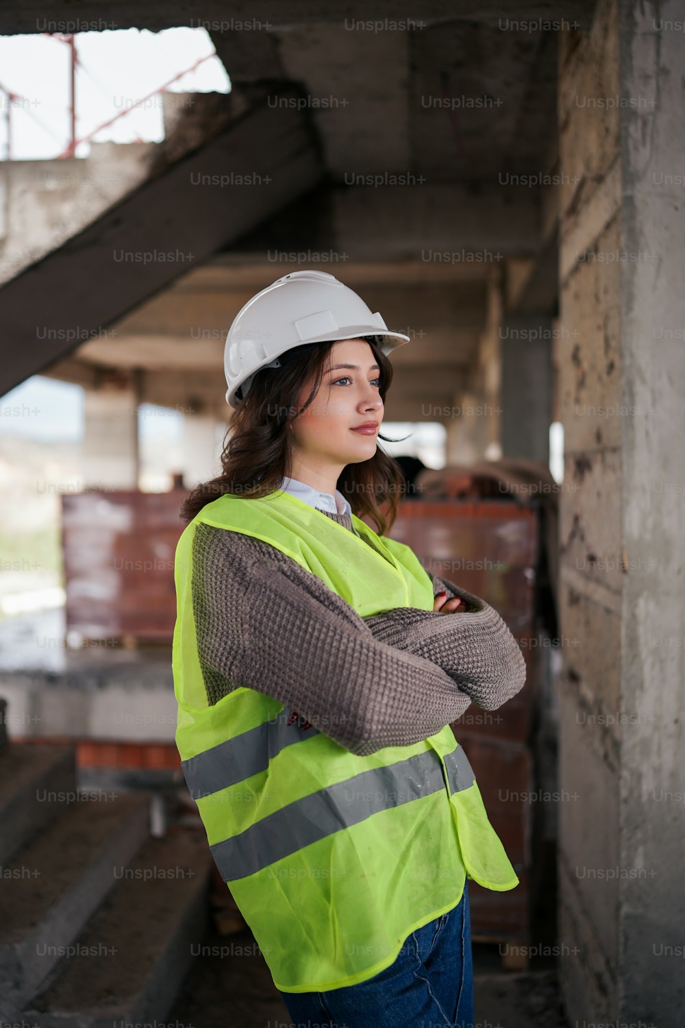 a woman wearing a hard hat and safety vest