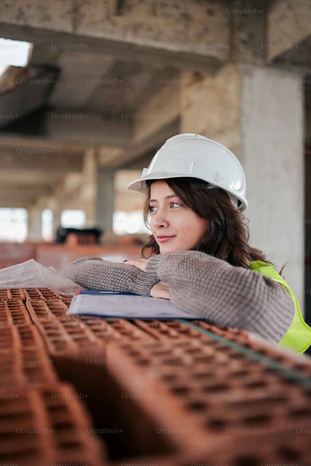 a woman wearing a hard hat and gloves