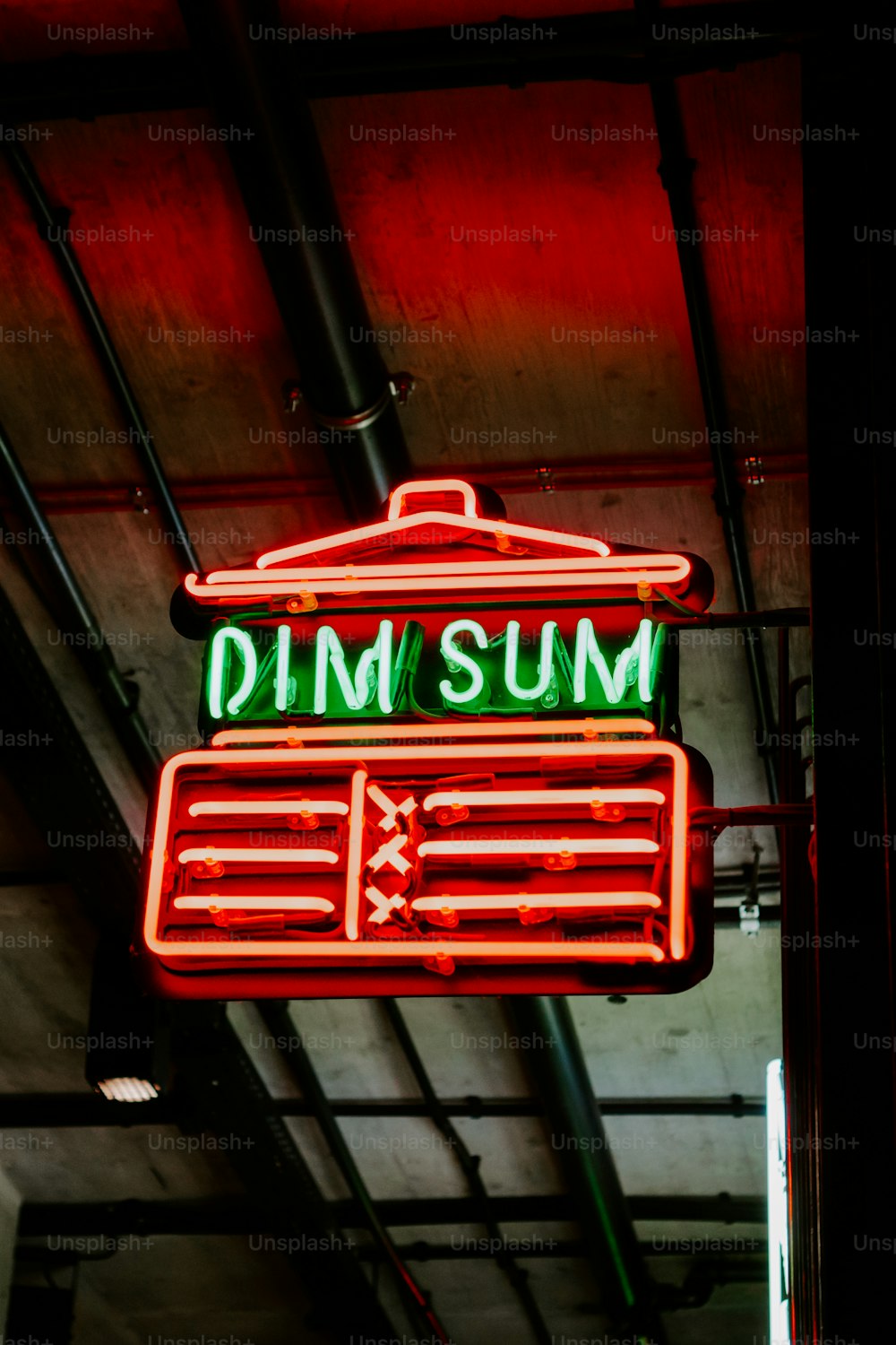 a neon sign hanging from the side of a building