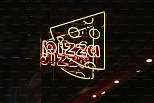 a neon sign hanging from the side of a building