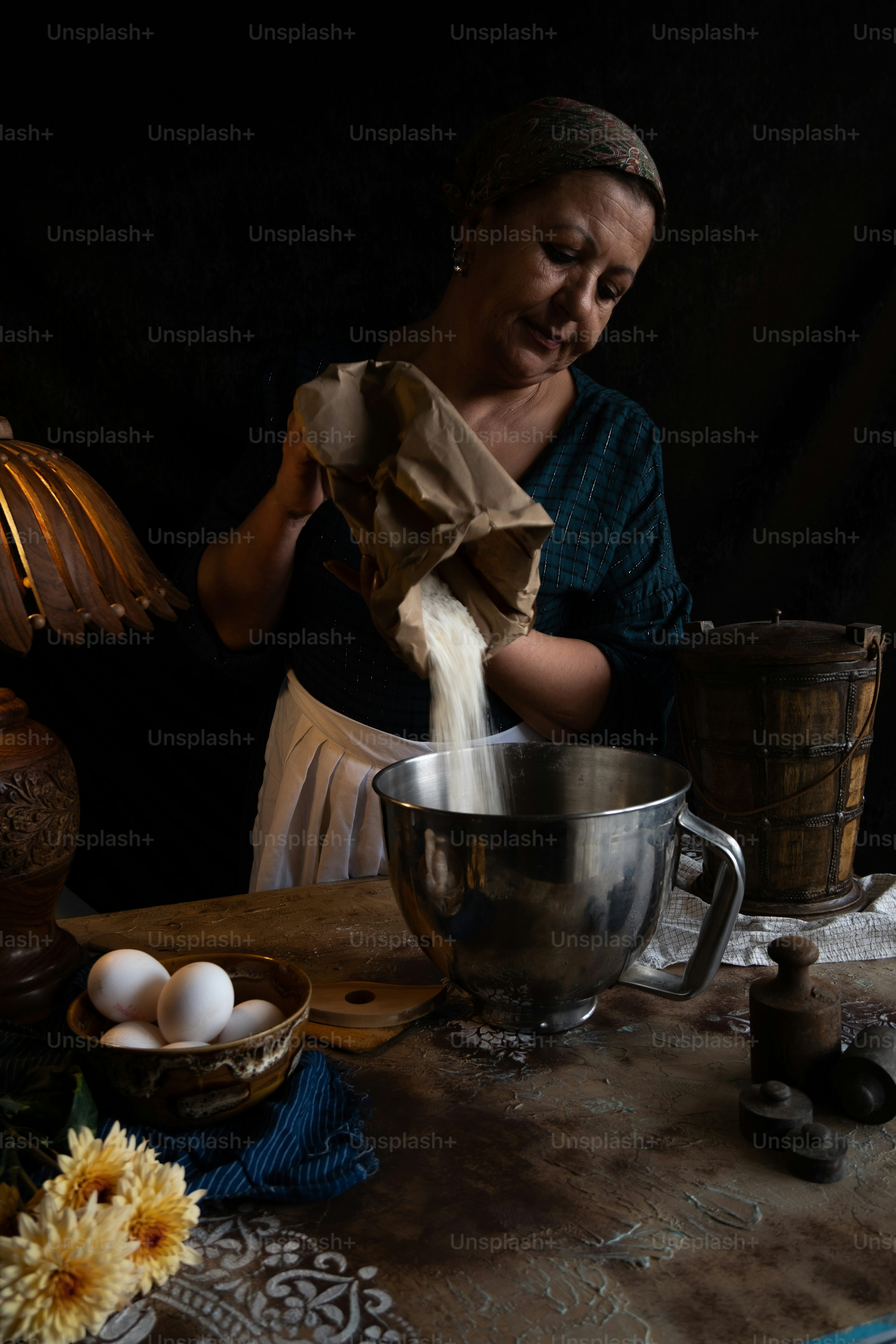 a woman in a blue shirt and a silver bowl