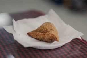 a piece of food sitting on top of a napkin