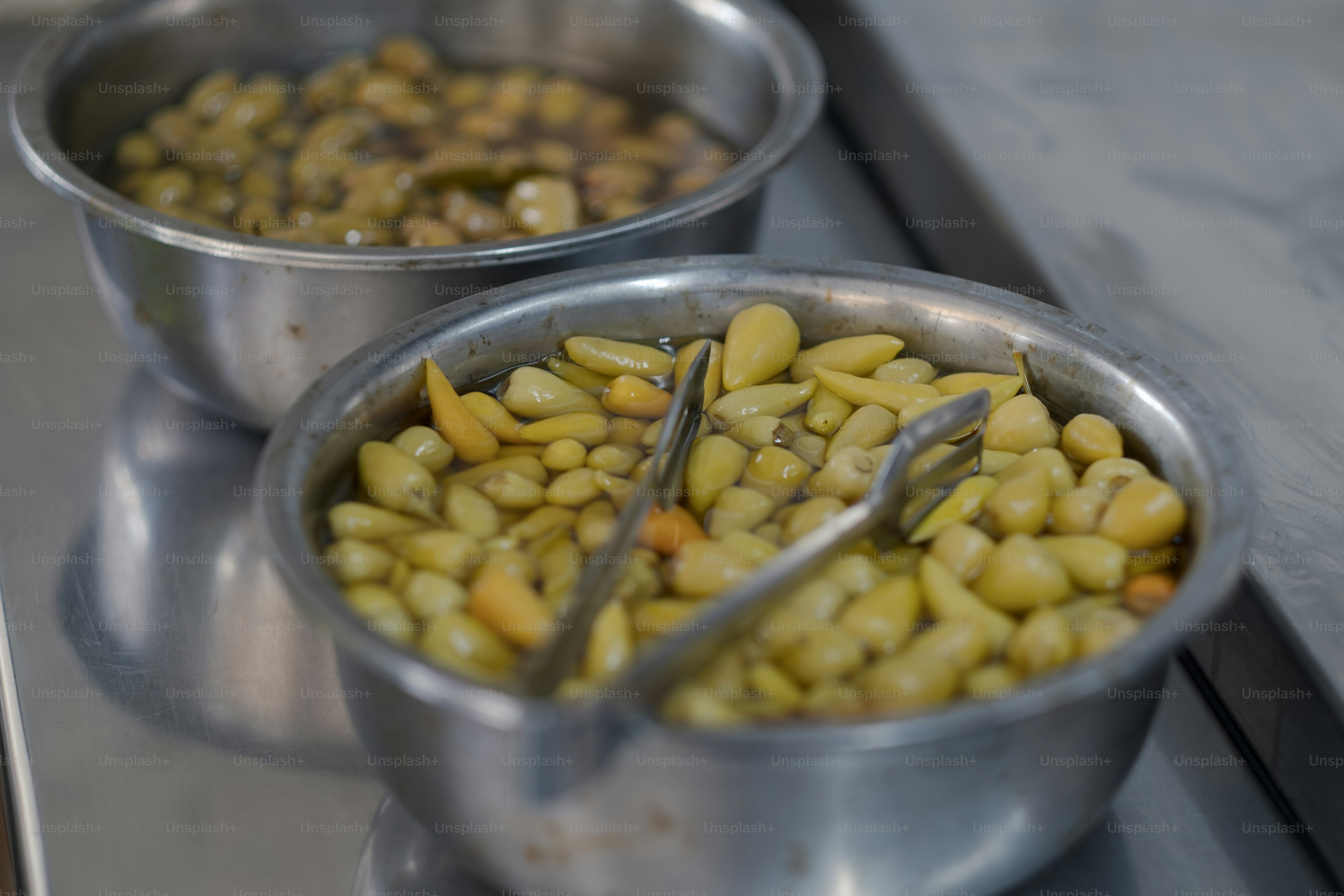 a couple of metal bowls filled with food