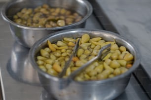 a couple of metal bowls filled with food