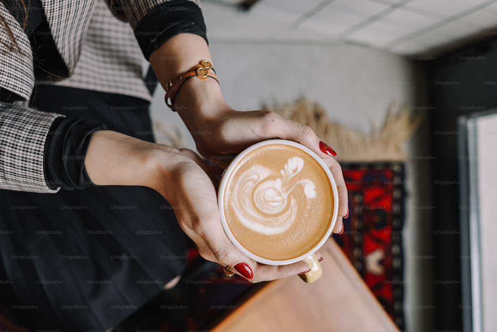 a woman is holding a cup of coffee