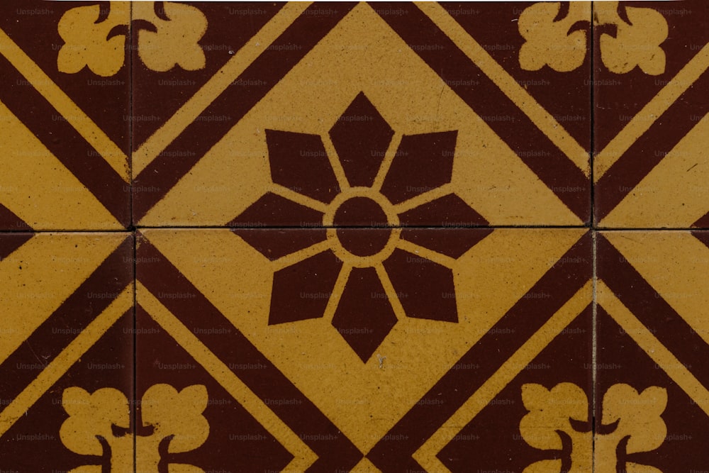 a close up of a tile with a flower on it