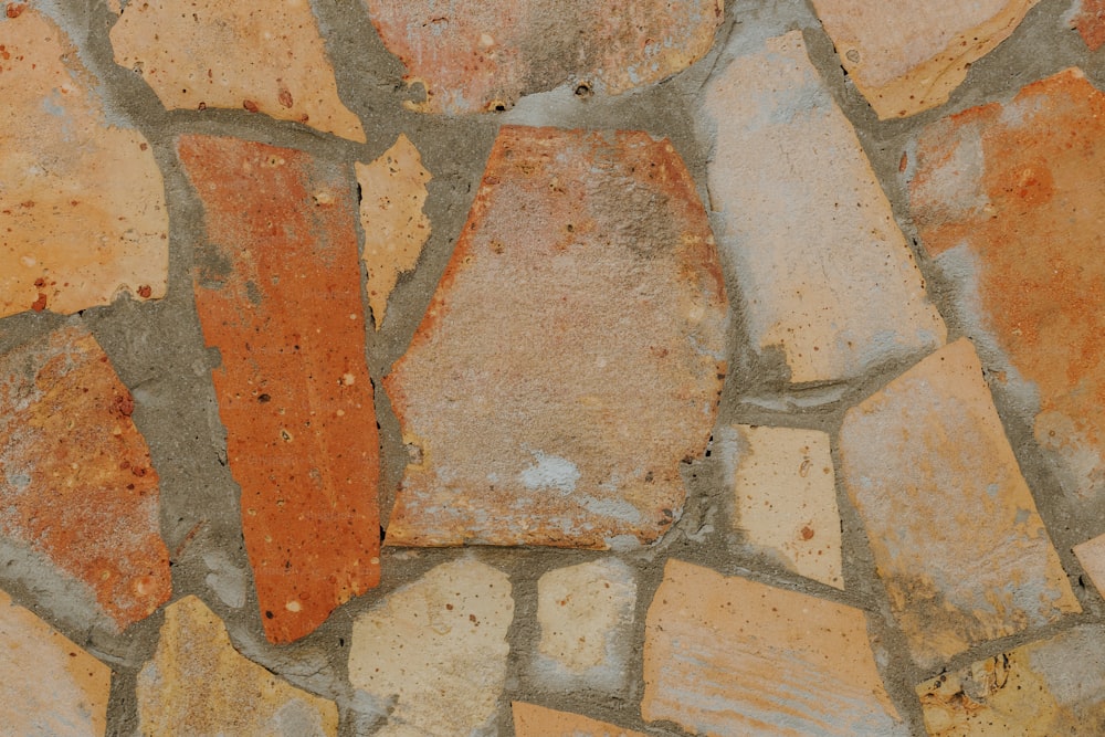 a close up of a stone wall with a clock on it