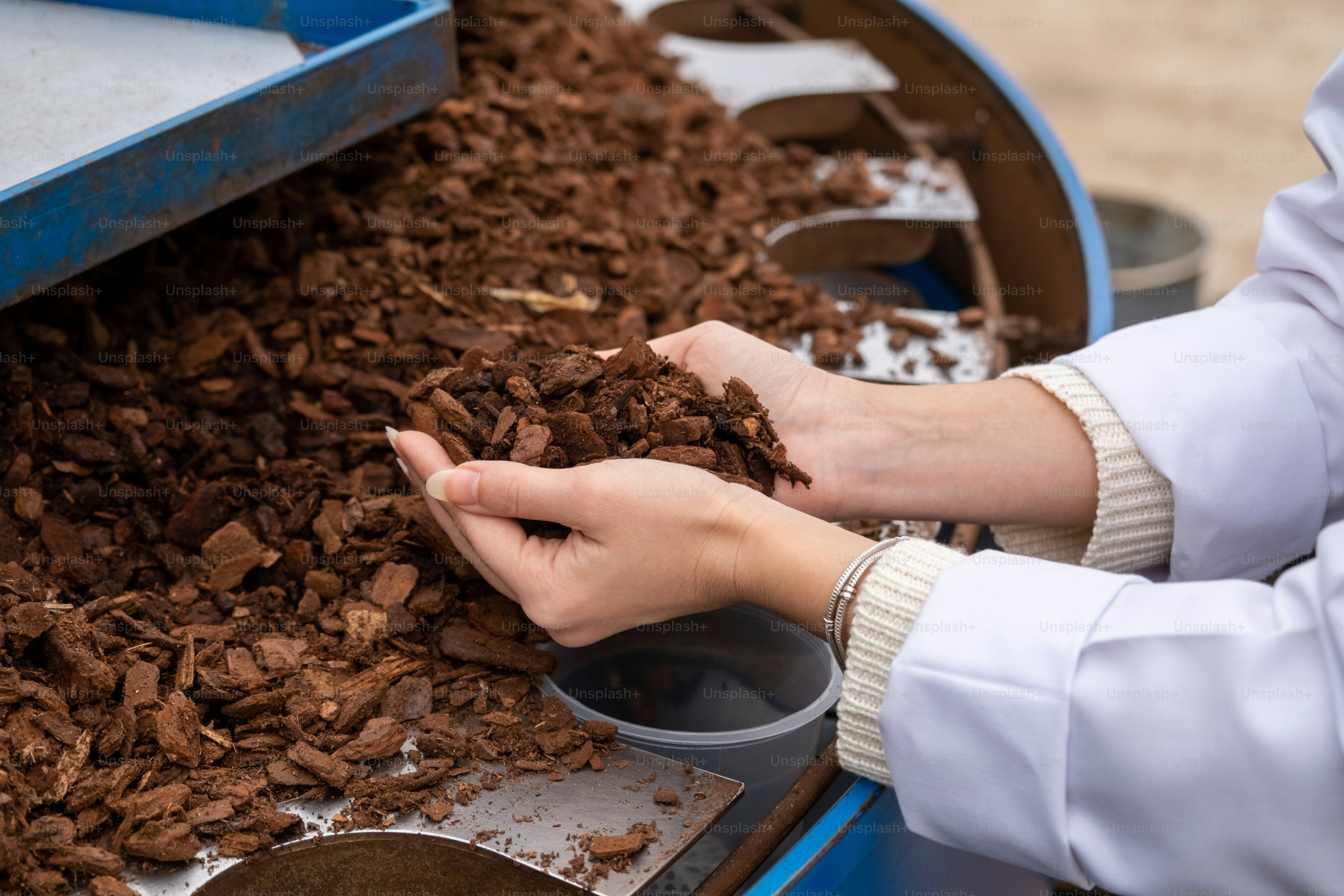 a person is scooping chocolate out of a bin