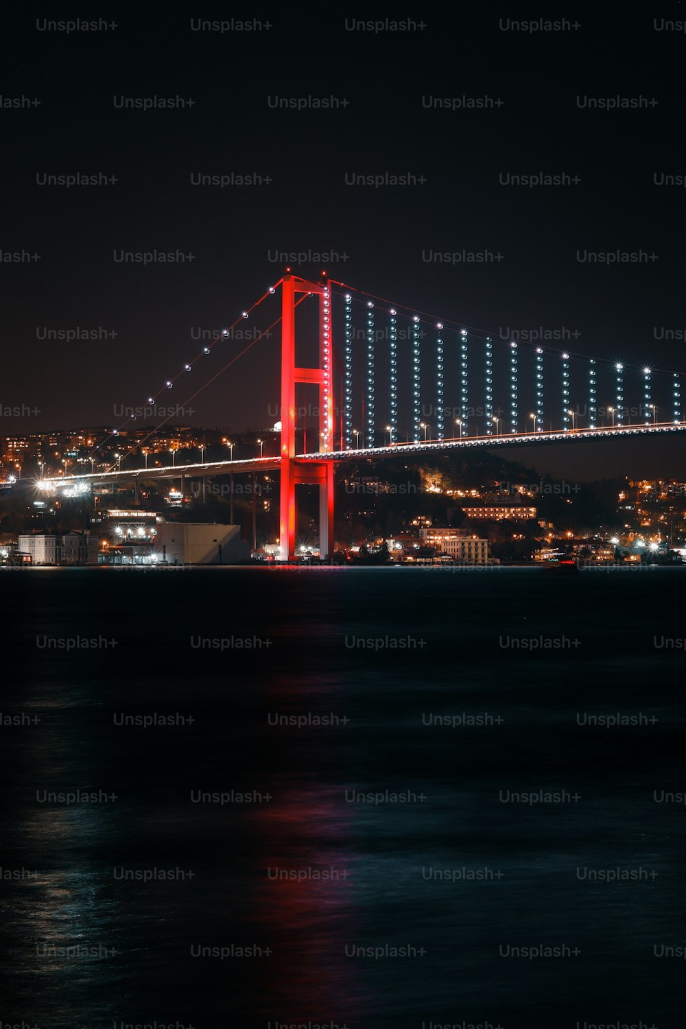 a large bridge over a body of water at night