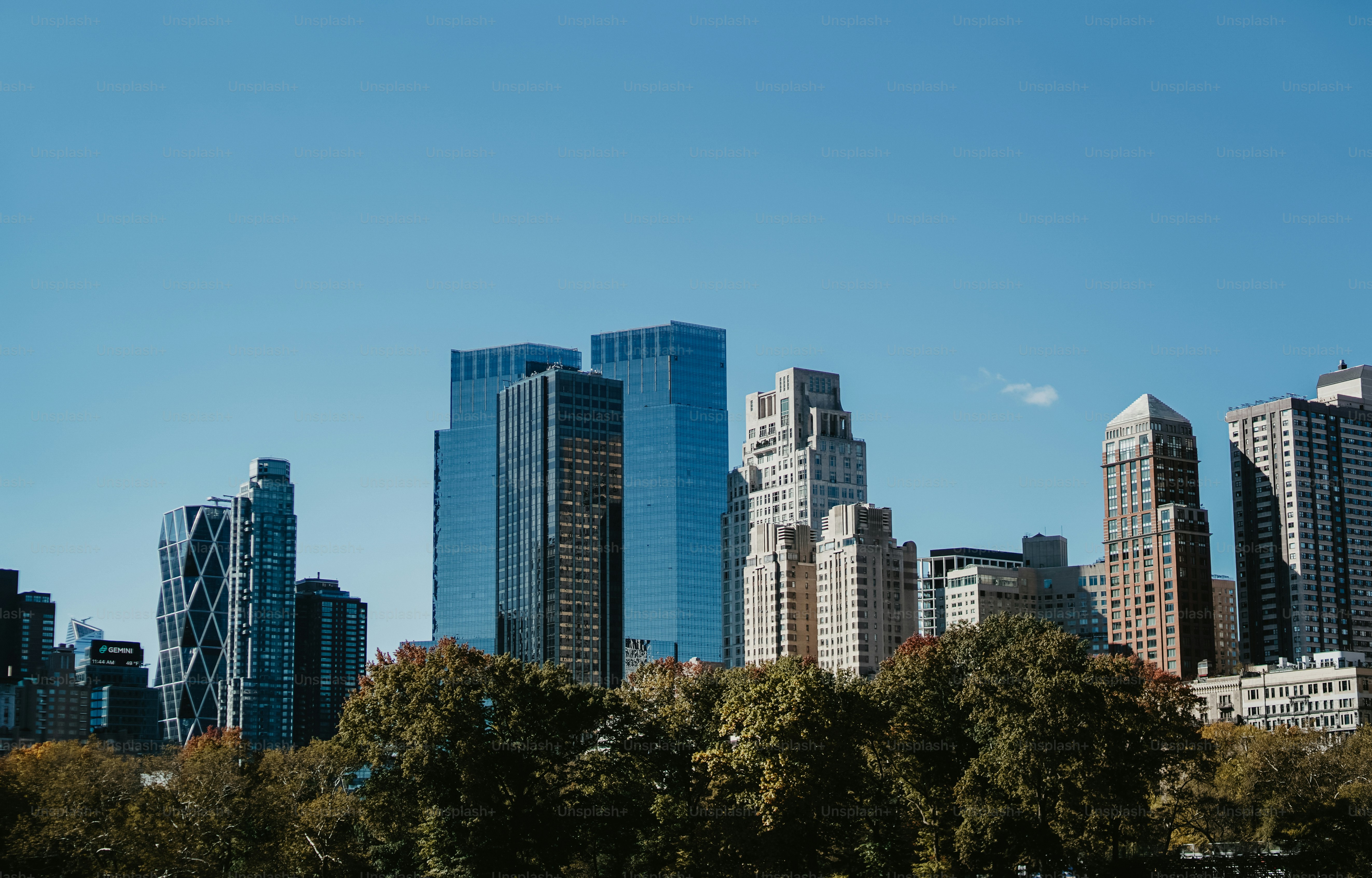 a city skyline with tall buildings and trees
