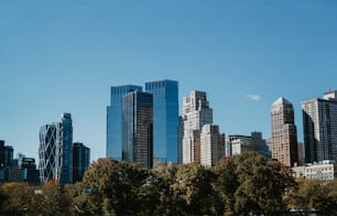 a city skyline with tall buildings and trees
