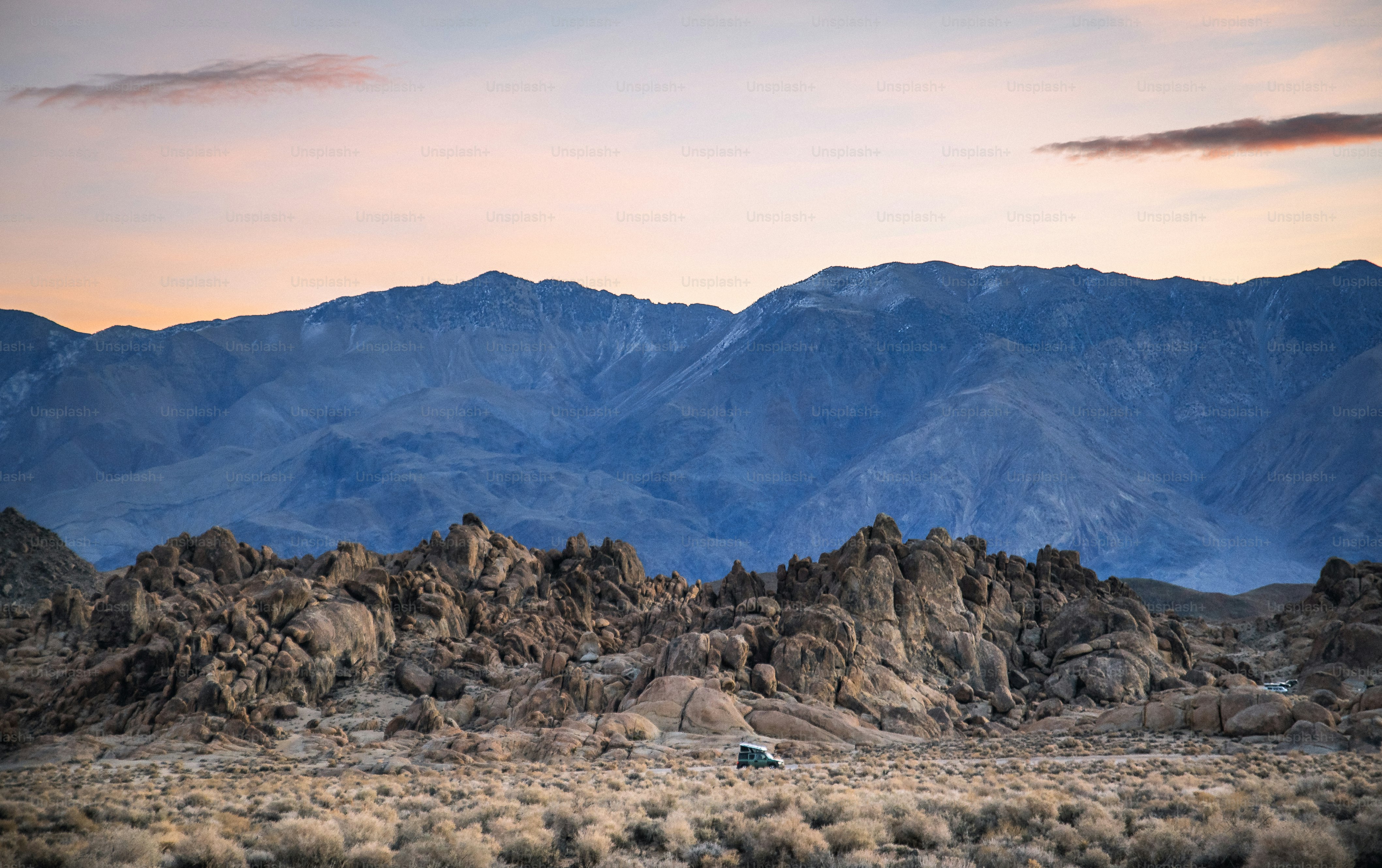 a truck is parked in front of a mountain range