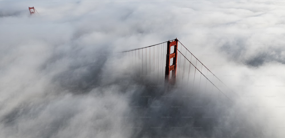 an aerial view of the golden gate bridge in the clouds